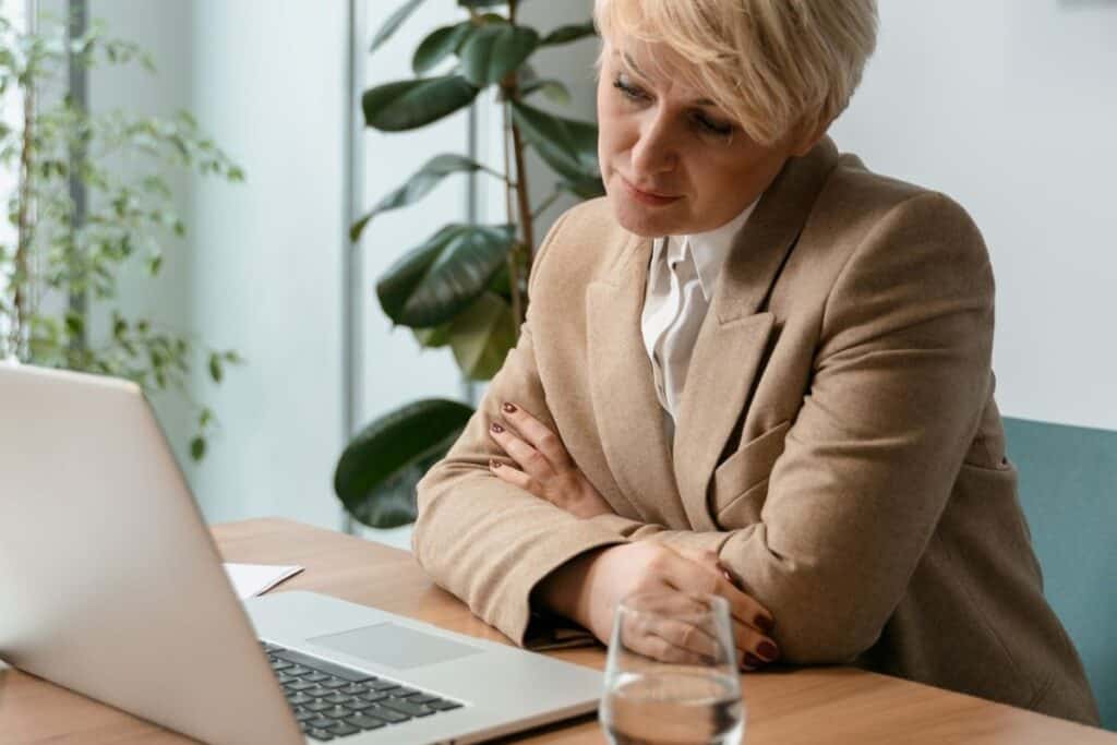 woman considering pros cons of reinvesting dividends