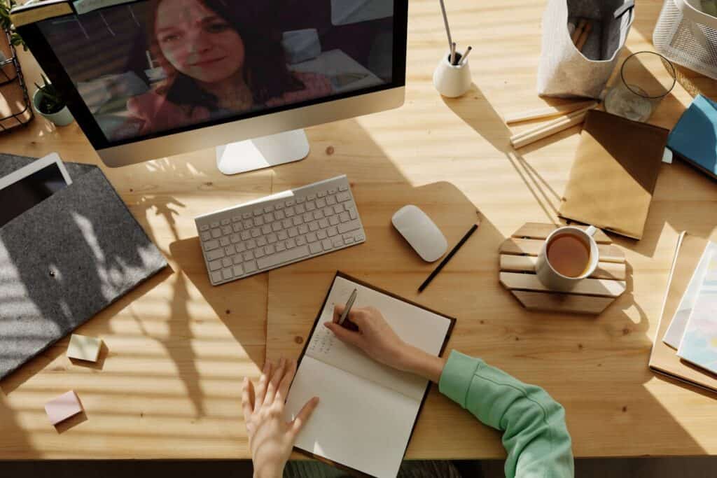 woman journaling at her desk at work
