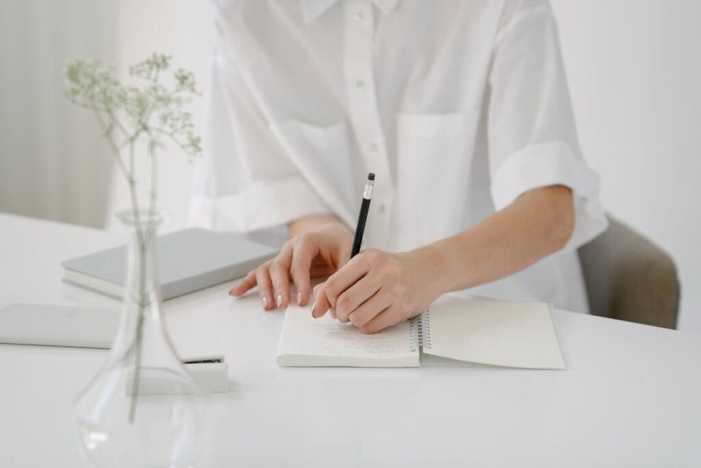 woman wrapping up month writing in notebook