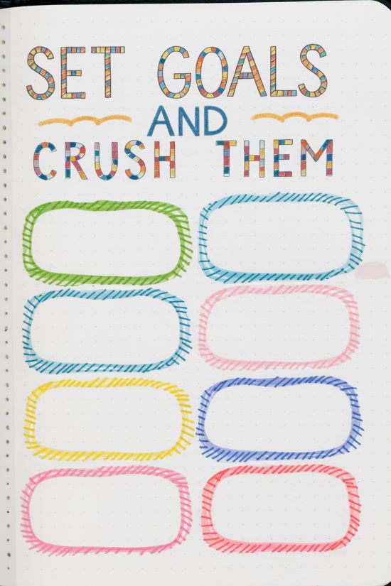 bullet journal goals page with words set goals and crush them